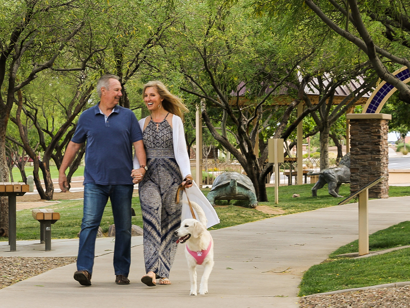 Man and woman walking their dog